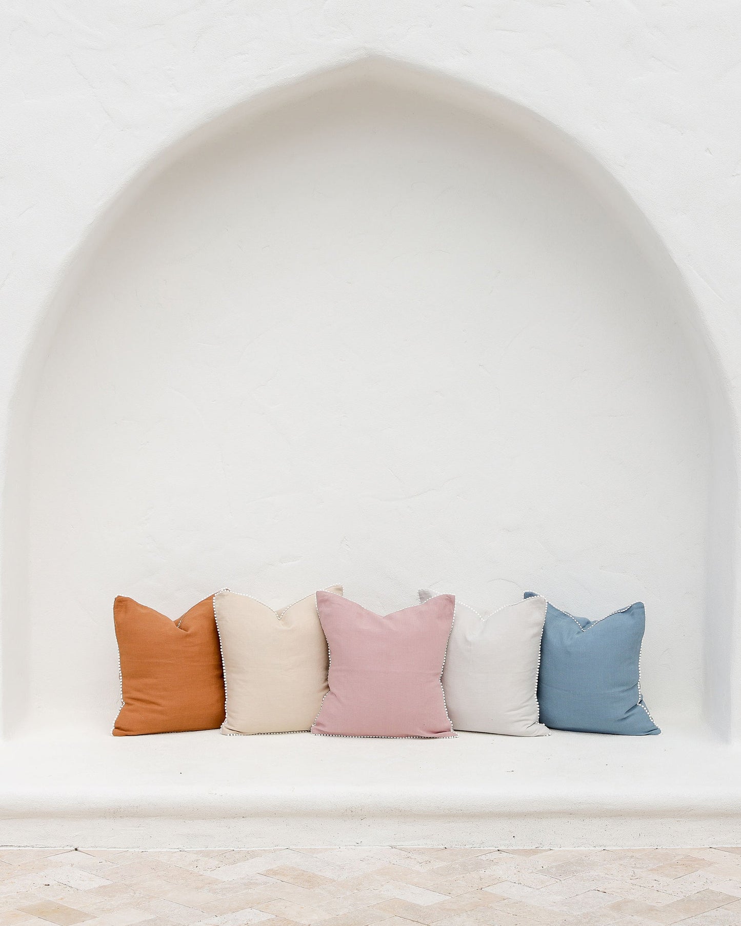 Cushion cover with pom poms in Woodrose - MagicLinen
