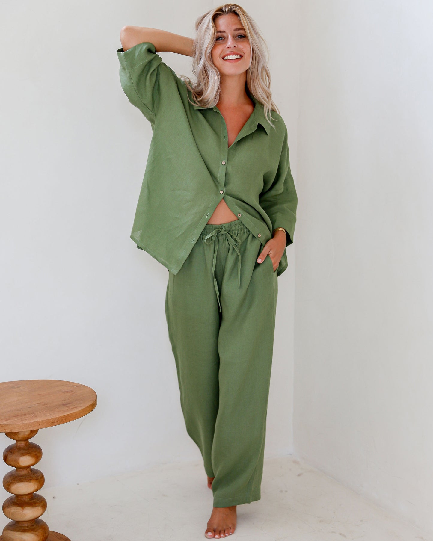 Forest Green linen pajama set AVEIRA on model showing button shirt and drawstring pants