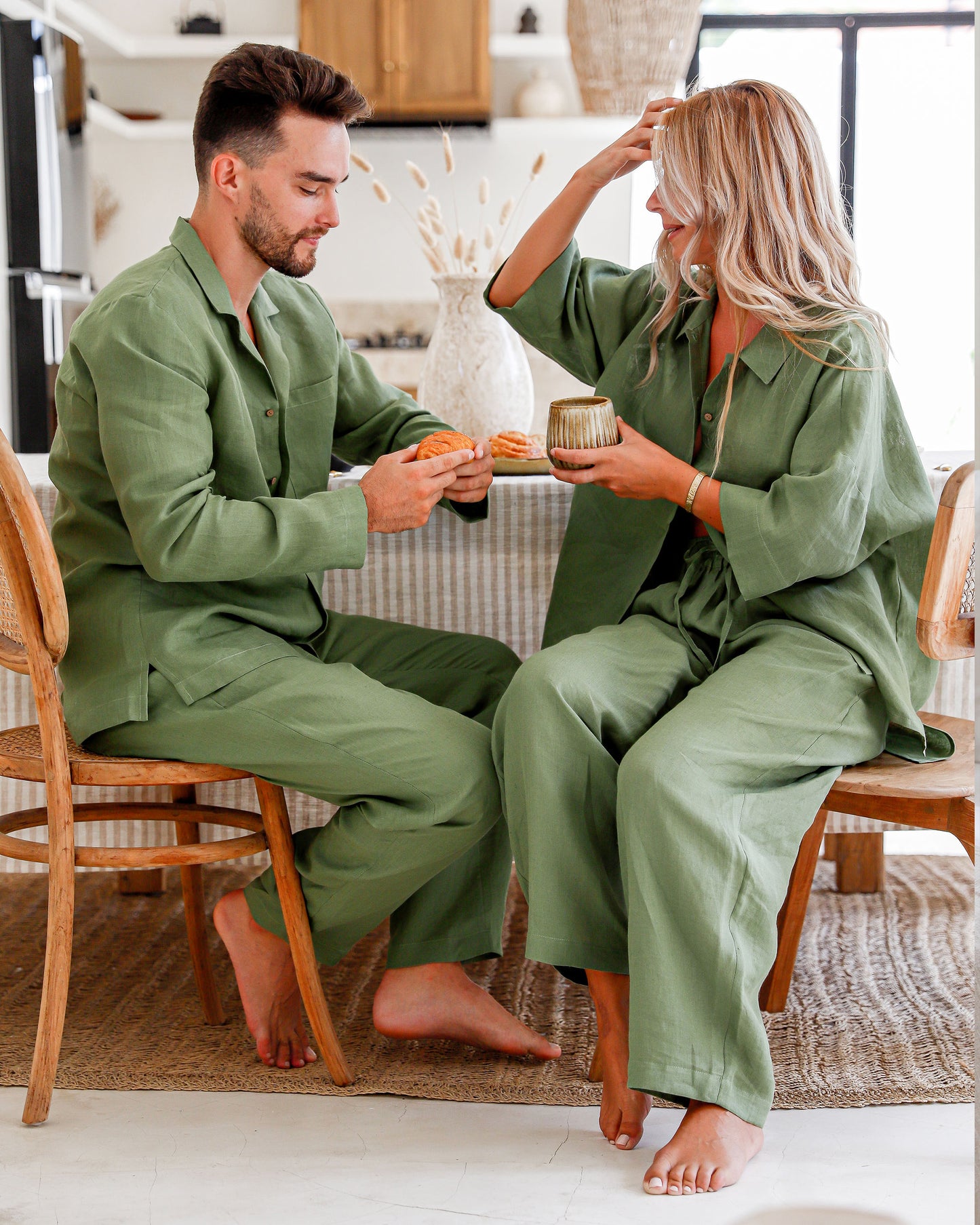 Pajama set folded on linen bedspread in natural light