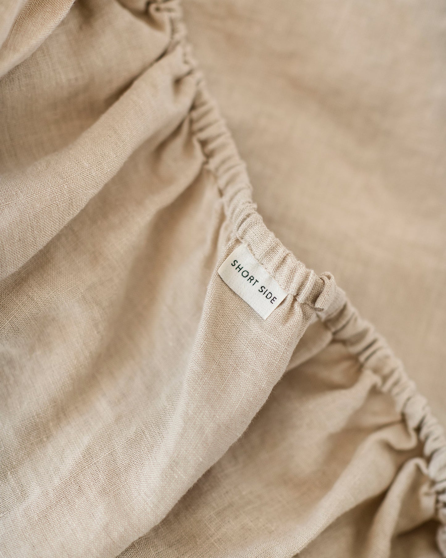 Oatmeal natural linen bedding set displayed on queen bed