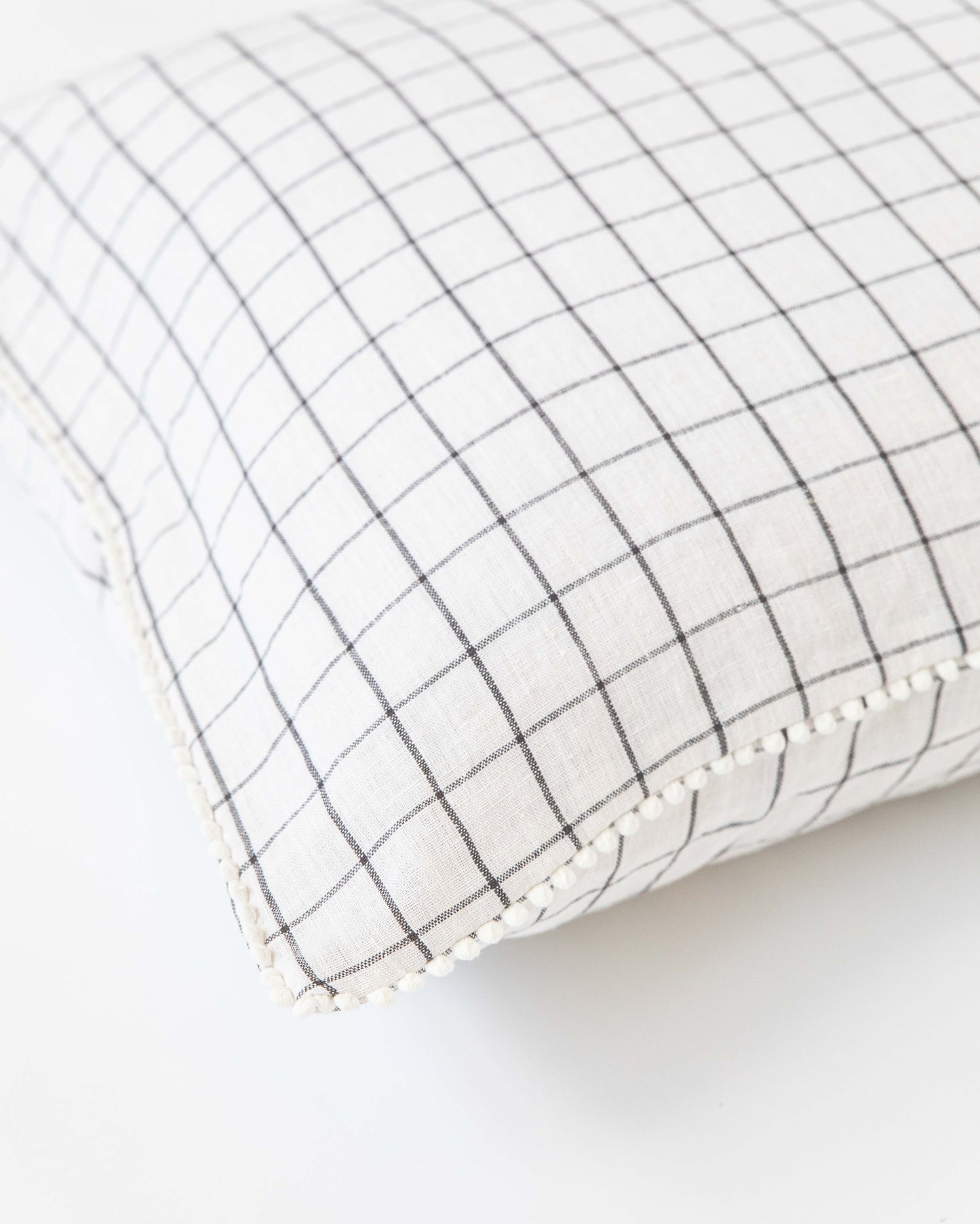 Cushion cover with pom poms in Charcoal grid - MagicLinen