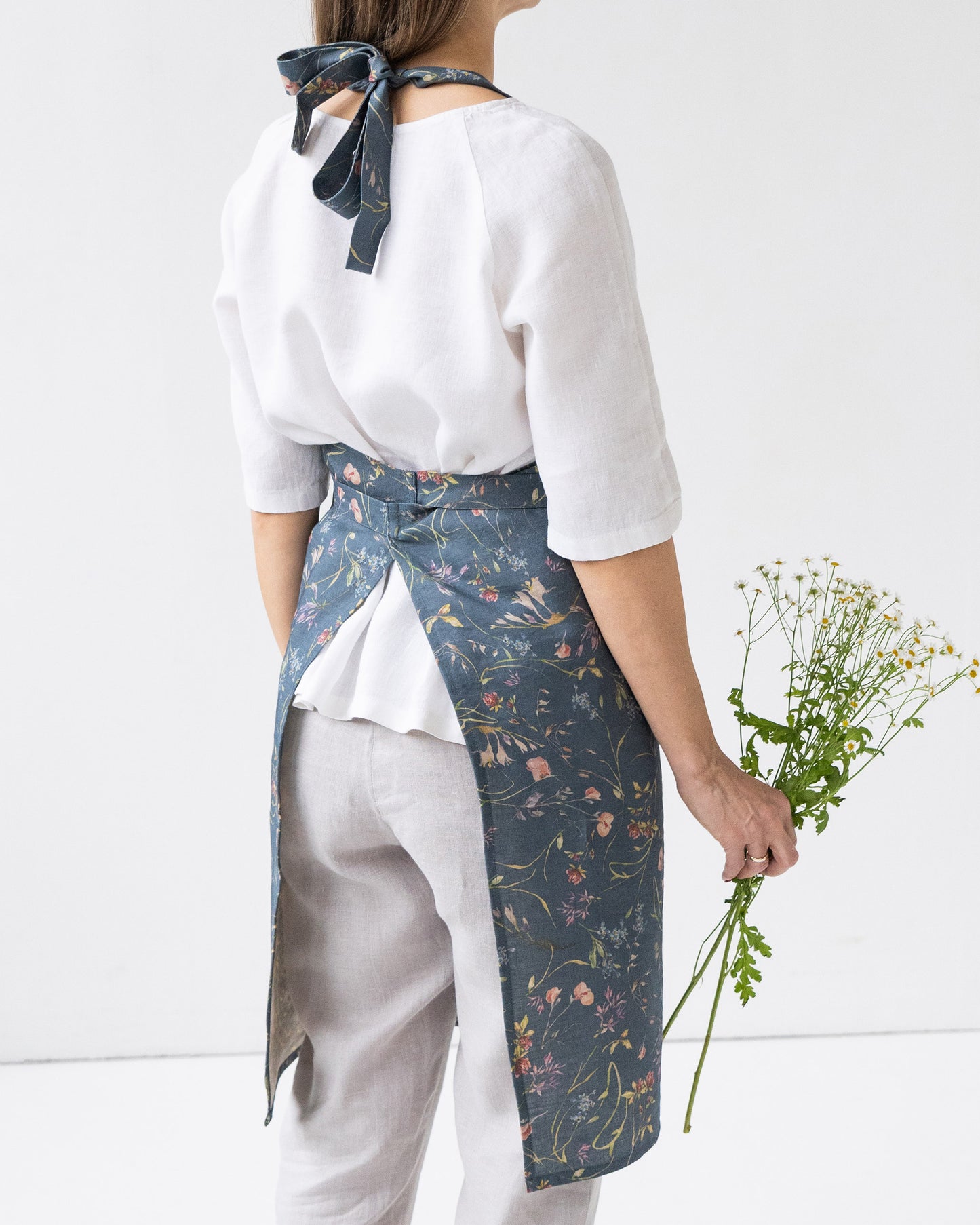Linen bib apron in Wildflowers print on deep navy blue | MagicLinen