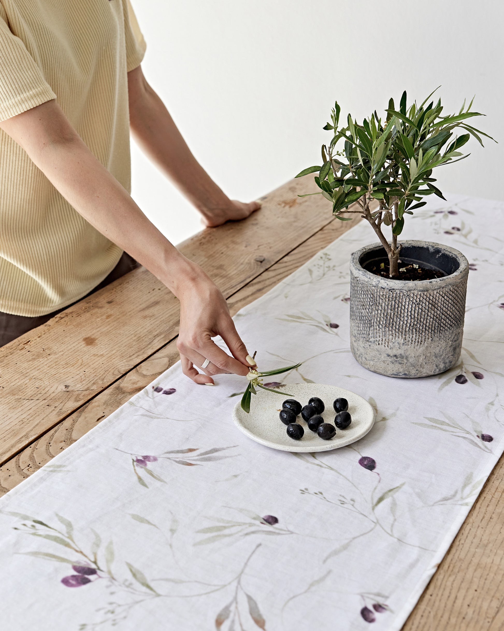 Linen Table Runner in Olive orchard print on white | MagicLinen