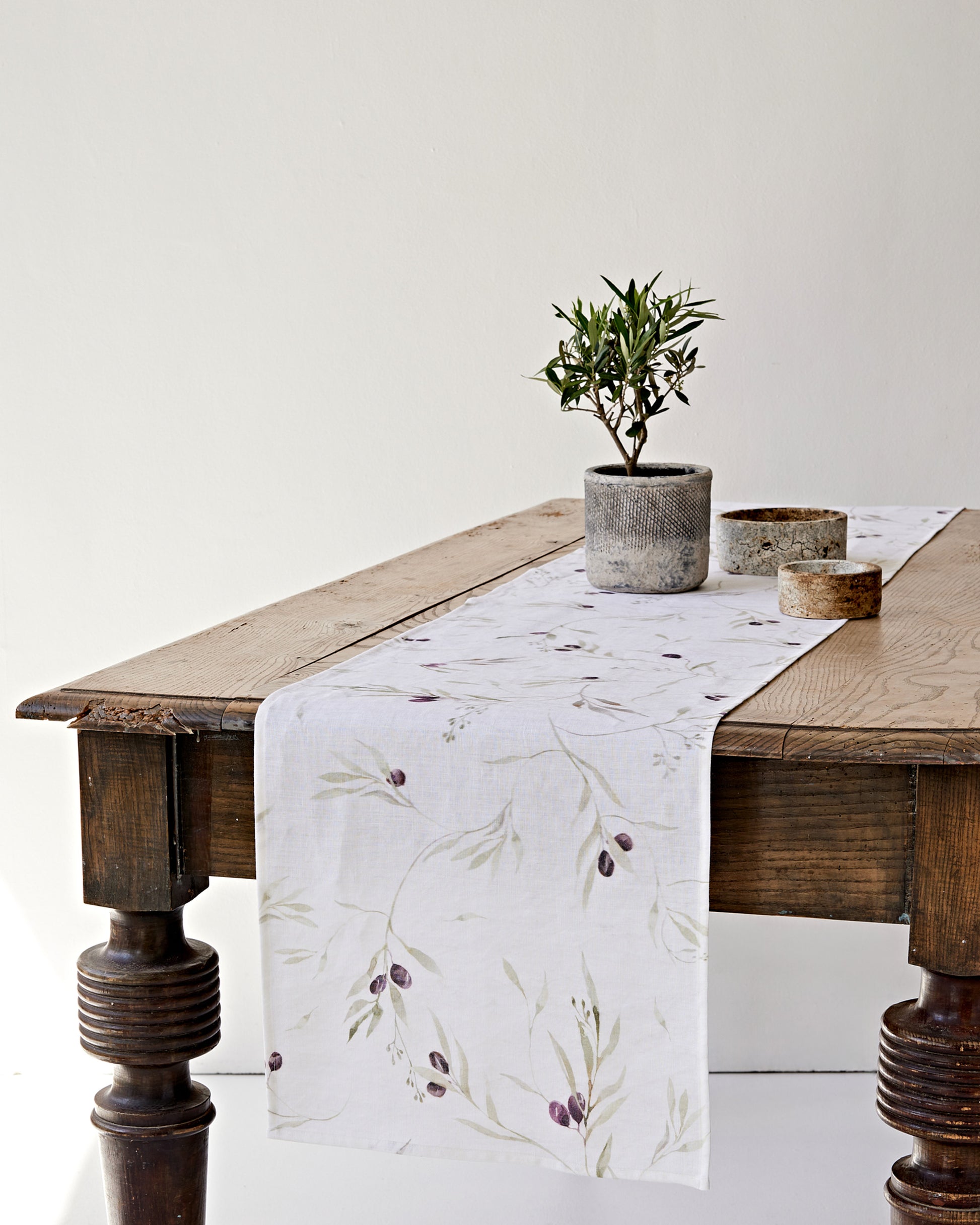 Linen Table Runner in Olive orchard print on white | MagicLinen