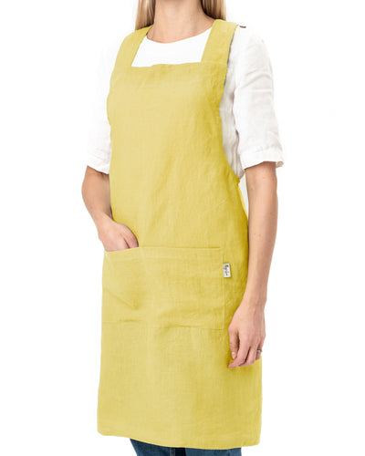 Pinafore cross-back linen apron in Moss yellow