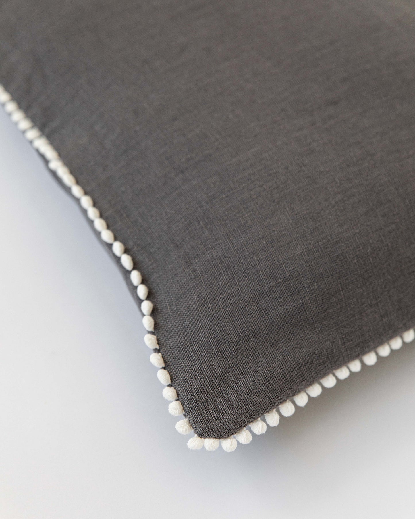 Cushion cover with pom poms in Charcoal gray - MagicLinen